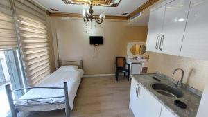 a small room with a bed and a sink at Aksu Otel in Aliağa +18 photos