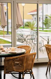a patio with a table and chairs on a balcony at Residhome Arcachon Plazza in Arcachon