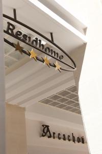 a sign for a restaurant with stars hanging from the ceiling at Residhome Arcachon Plazza in Arcachon