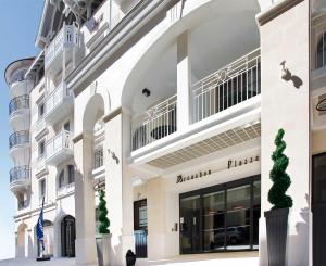 a large white building with a store front at Residhome Arcachon Plazza in Arcachon