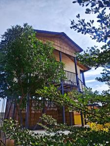 a house with a balcony on the side of it at Raghuvan Farm in Jaipur