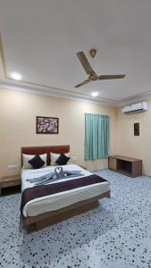 a bedroom with a bed and a ceiling fan at Raghuvan Farm in Jaipur +17 photos