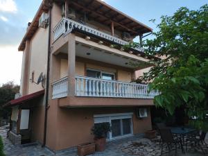 a building with a balcony on the side of it at Eva Maisonette in Iraklitsa