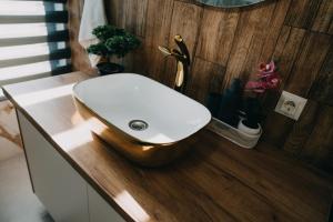 a white sink on a counter in a bathroom at Nordic Cabin in Bughea de Jos +36 photos