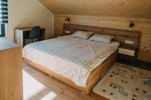 a bedroom with a bed and a wooden wall at Nordic Cabin in Bughea de Jos
