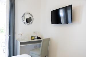 a room with a mirror and a chair and a desk at Relais Villa Anna in Anacapri