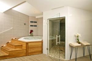 a bathroom with a tub and a glass shower at Residhome Arcachon Plazza in Arcachon +37 photos