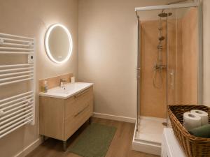 a bathroom with a sink and a shower at Le Refuge de Mandrin, Elegance et tranquilité in Saint-Genix-sur-Guiers