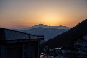 a sunset over a city with mountains in the background at yutori-nozawa in Nozawa Onsen