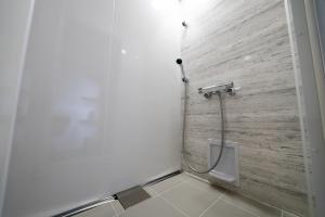 a bathroom with a toilet with a wooden wall at yutori-nozawa in Nozawa Onsen +6 photos