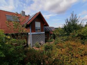 a house with solar panels on the roof at Ferienhaus Nebenan Plus in Ebern