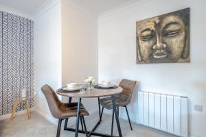 a dining room with a table and chairs at Ascot Racecourse Apartment in Ascot
