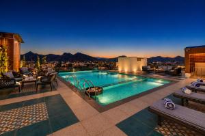 a pool with a view of the mountains at Paradise Bliss Udaipur - Luxury Boutique Hotel in Udaipur