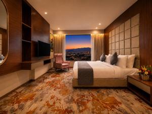 a bedroom with a large bed and a large window at Paradise Bliss Udaipur - Luxury Boutique Hotel in Udaipur +53 photos