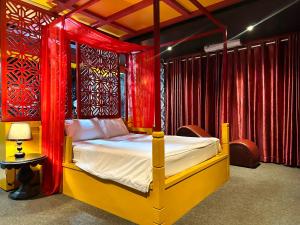 a bedroom with a bed with red curtains at Zenshunga Hotel Yên Hoà- Hà Nội in Hanoi