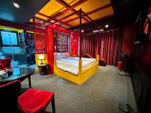 a bedroom with a bed in a room with red curtains at Zenshunga Hotel Yên Hoà- Hà Nội in Hanoi
