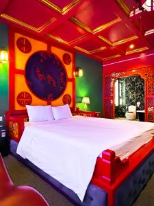 a bedroom with a large white bed with red walls at Zenshunga Hotel Yên Hoà- Hà Nội in Hanoi +43 photos