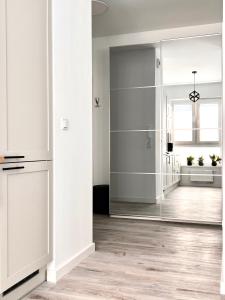 a room with a mirror and a hallway at Apartament Tosia in Chełm +7 photos