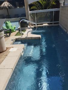 a swimming pool with blue water in a backyard at Camping les Acacias in Fréjus