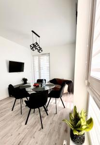 a living room with a table and chairs and a couch at Apartament Tosia in Chełm