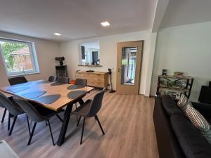 a living room with a table and chairs and a couch at Ferienhaus Hirschi in Eisenach