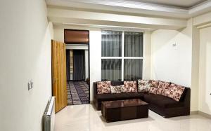 a living room with a couch and a table at Gulbahar Residences in Kabul