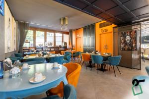 a dining room with tables and chairs at Hotiday Milano CityLife in Milan
