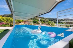 a swimming pool with a swan in the water at Yeosu Little Forest Pension in Yeosu