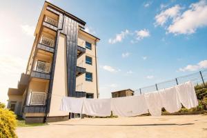 a building with a clothes line in front of a building at Yeosu Little Forest Pension in Yeosu