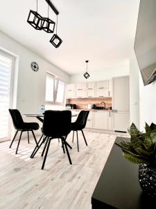 a kitchen and dining room with a table and chairs at Apartament Tosia in Chełm