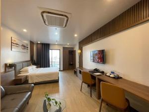 a hotel room with a bed and a couch at ZEN RIVERSIDE HOTEL & RESIDENCES in Hai Phong