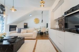 a living room with a couch and a table at Liberty Central Apartment in Tuzla