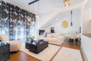a living room with a couch and a table at Liberty Central Apartment in Tuzla