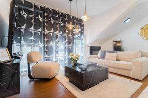 a living room with a couch and a table at Liberty Central Apartment in Tuzla +50 photos