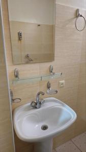 a bathroom with a sink and a mirror at Sitora in Chirchiq