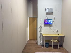a room with a desk with a computer on a wall at Kamar Pluit Karang in Jakarta +15 photos
