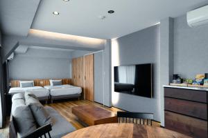 a living room with a couch and a bed at ulu Tokyo in Tokyo