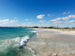 a beach with the ocean and the water at Waves at Jurien, Villa 9-23 Dalton Street in Jurien Bay