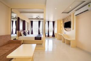 a large room with a bed and a couch at Devbhoomi Inn in Deoghar