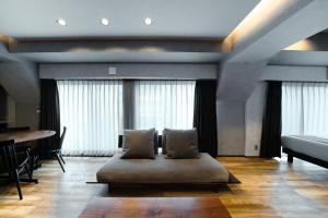 a bedroom with a bed with pillows on the floor at ulu Tokyo in Tokyo