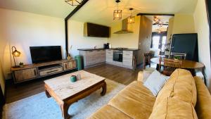 a living room with a couch and a table at Family holiday home by beach and forest in Dirkshorn
