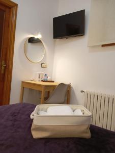 a room with a bed with a chair and a mirror at Hotel Carabela La Pinta in Baiona