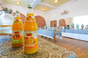 two bottles of orange soda sitting on a table at Strandhotel Pichler in Seeboden