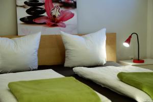 ヘルマゴルにあるPro's Apartmentのベッドルーム1室(ベッド2台、ランプ、壁に花付)