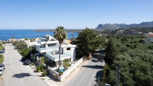 an aerial view of a white house with palm trees at D PALM Premium Living - Kalathas, Chania in Chania