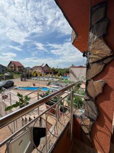 a view of the pool from the balcony of a resort at Hypnotic Villa Pitesti in Piteşti