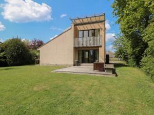 a building with a balcony on a grass field at Frater House in Alburgh