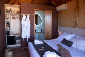 a bedroom with a bed with towels on it at D PALM Premium Living - Kalathas, Chania in Chania +140 photos