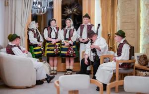 a group of people dressed in costumes standing in a room at Prispa Premium Resort in Vişeu de Sus