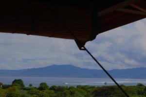 a view of the water and mountains from a tent at Lakey Peak Haven in Huu